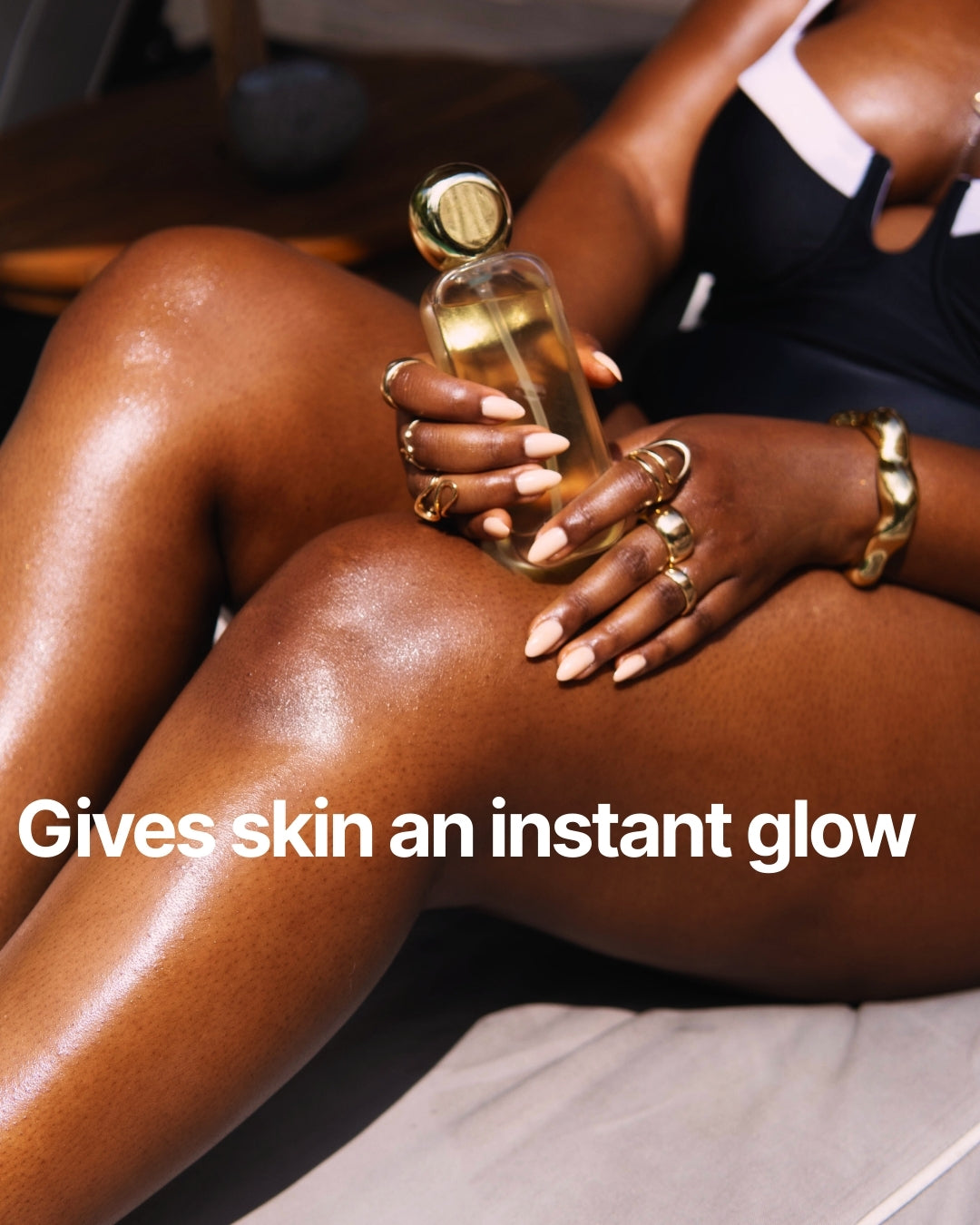 Person holding a bottle of skincare product with text 'Gives skin an instant glow'.