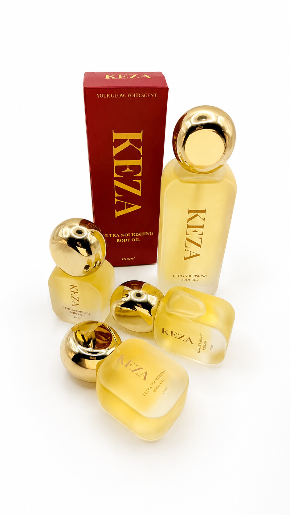 Five Keza fragrance bottles in a translucent pale yellow glass with shiny gold caps, arranged in front of a red Keza box on a white background.